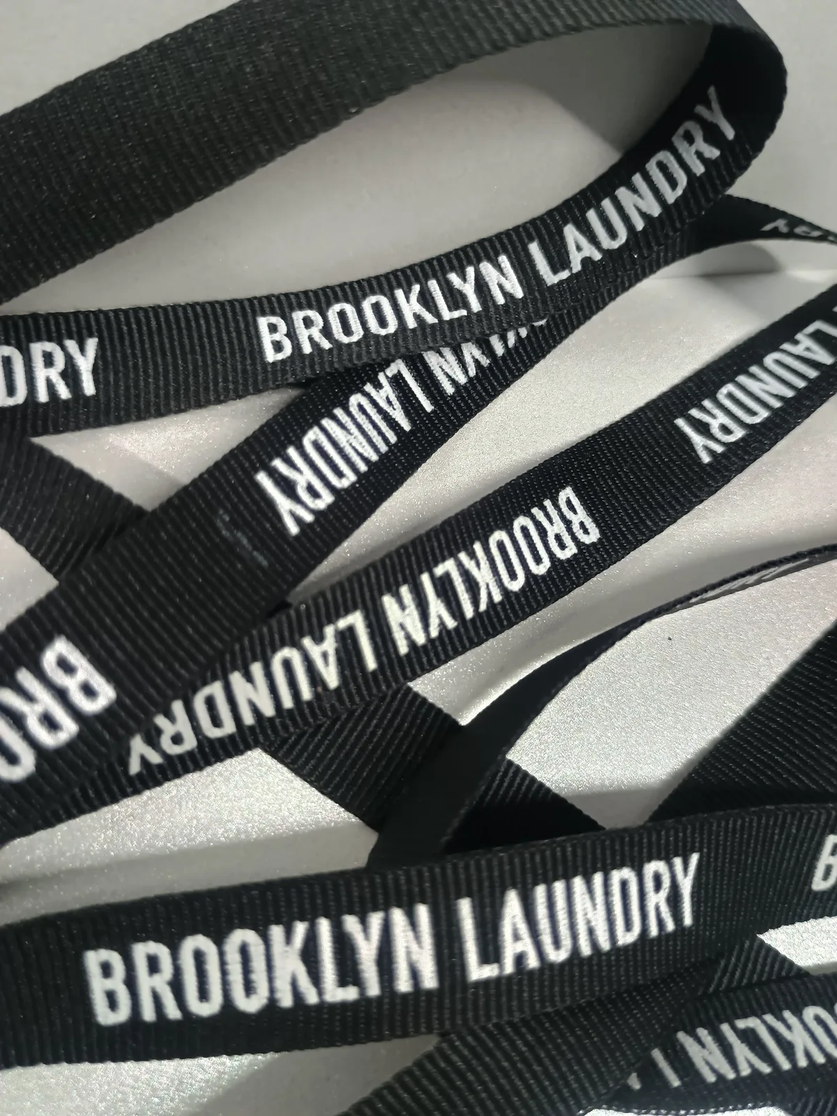Black ribbed ribbon with repeated white lettering