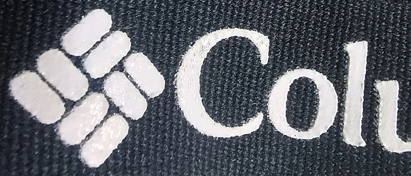 Macro view of a raised white print on dark textile