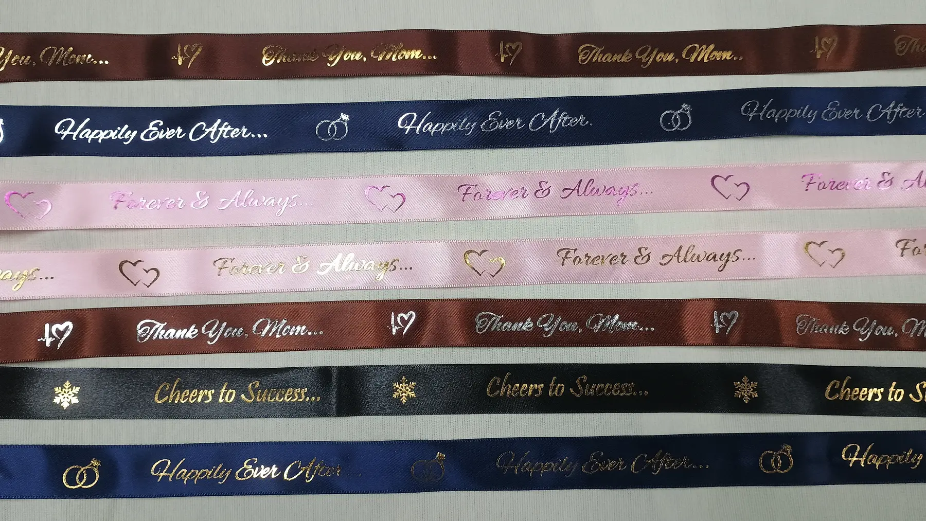Rows of satin ribbons with custom printed messages and foil details